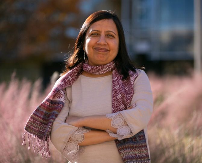 Dr. Aesha John, an associate professor of social work, poses outside 