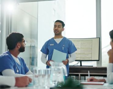 Physician Associate talking to his team