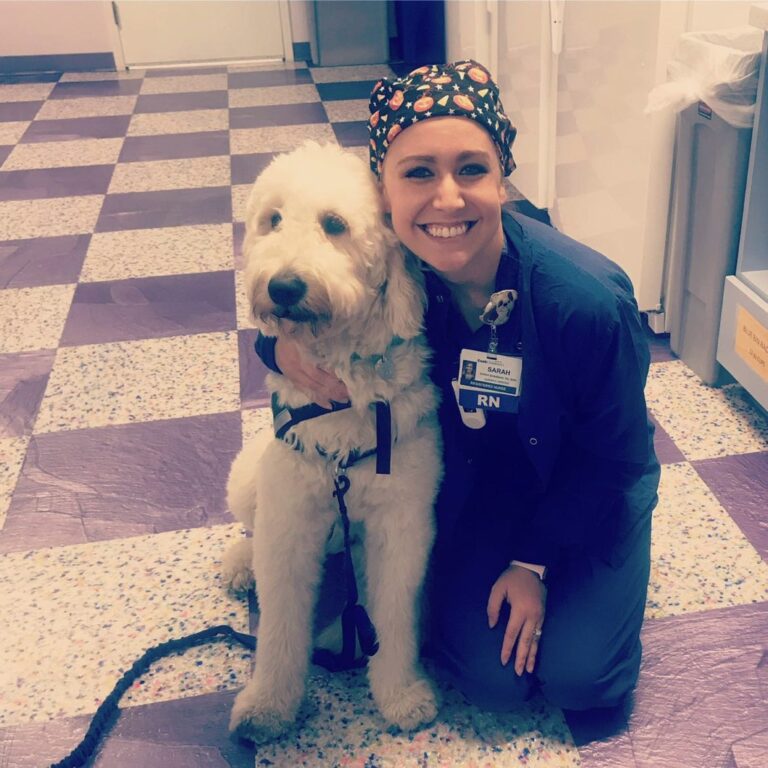 TCU alum Sarah Patzke Shaabani, ’14, RN posing with a dog